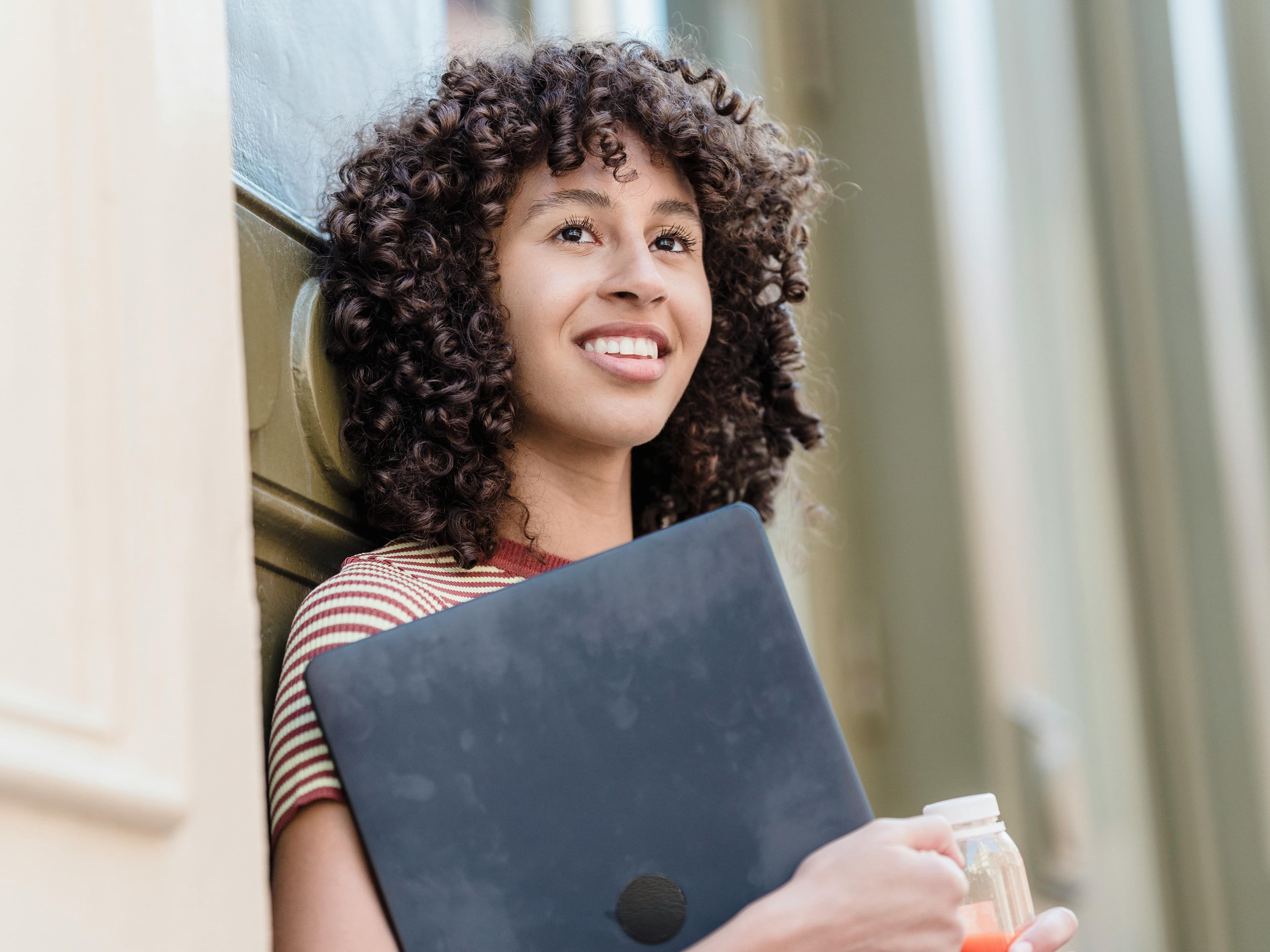 young woman with curly brown hair optimistic rectangle young woman with curly brown hair optimistic rectangle